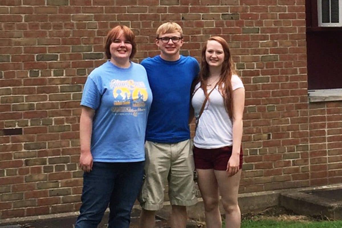 Three children standing posing together