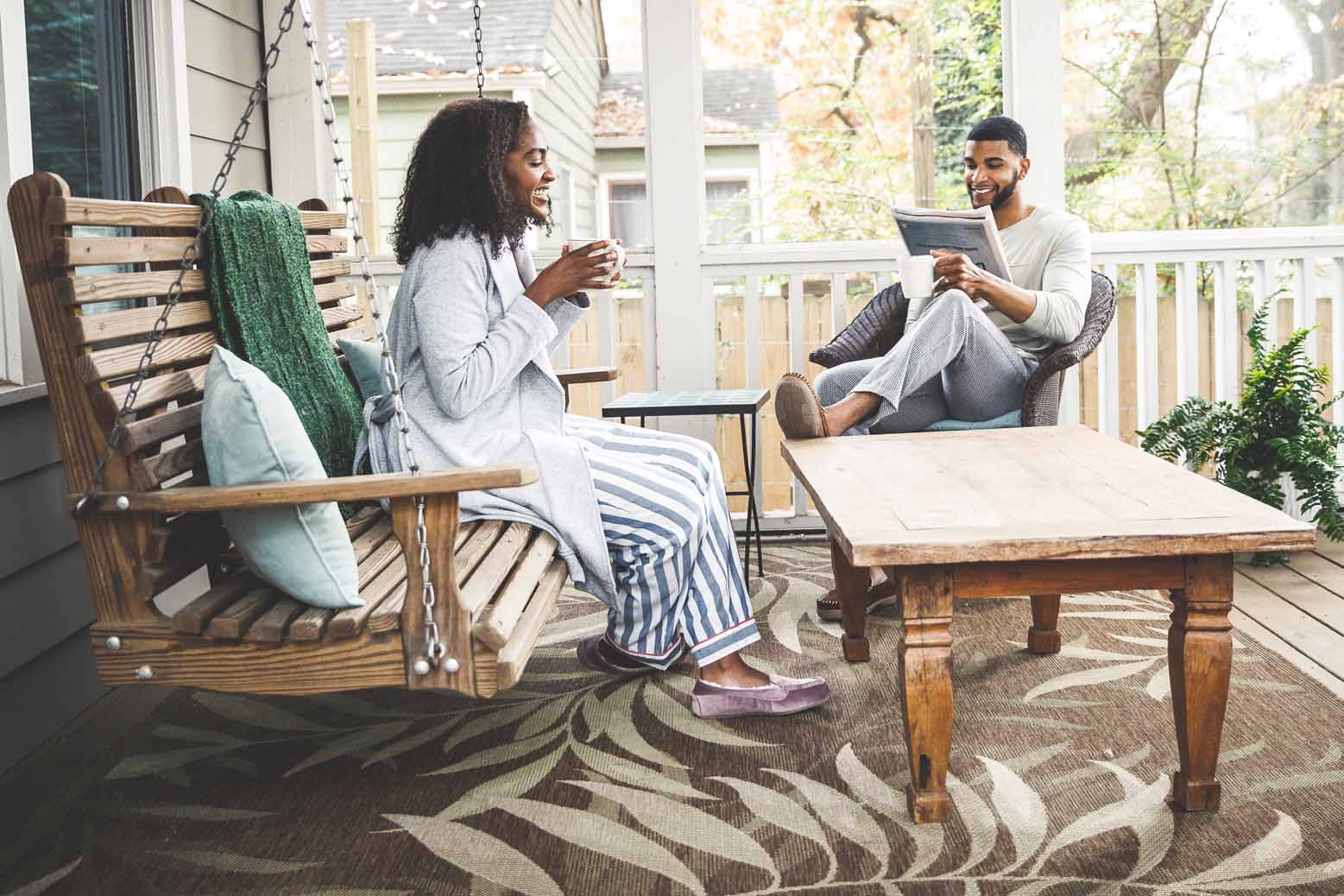 Couple having coffee on enclosed porch