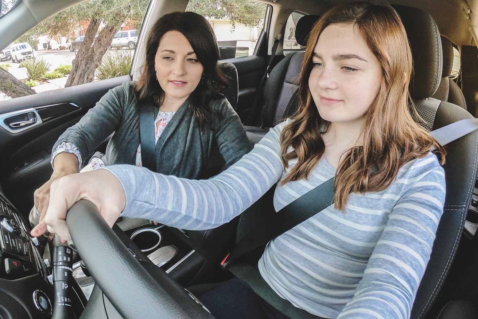 Mother teaching daughter how to drive
